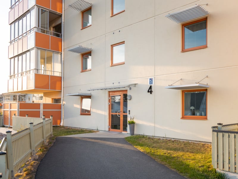 En lägenhetsbyggnad med en gångväg som leder till den.