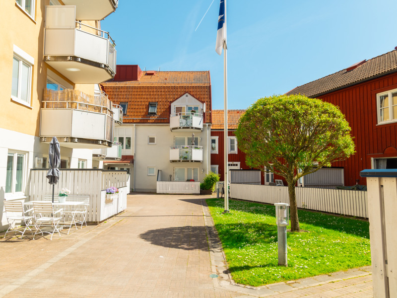 En gata i ett bostadsområde med en flagga på en stång.