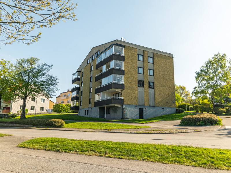 Ett hyreshus i ett gathörn i ett bostadsområde.