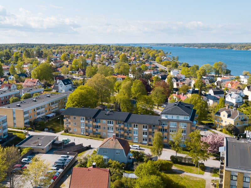 En flygbild av en stad med en sjö i bakgrunden.