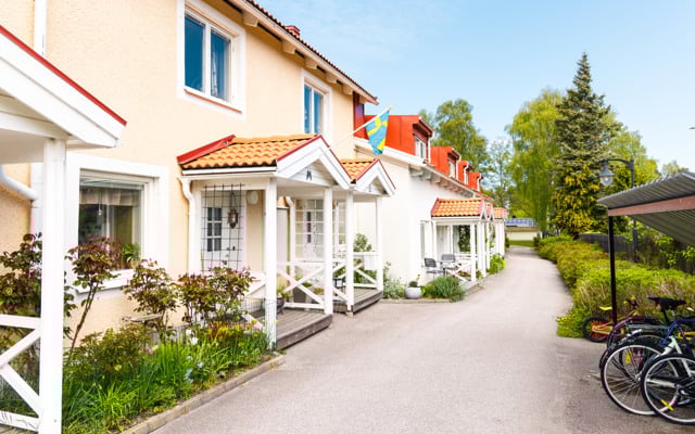 En cykel parkerad framför en rad med hus.