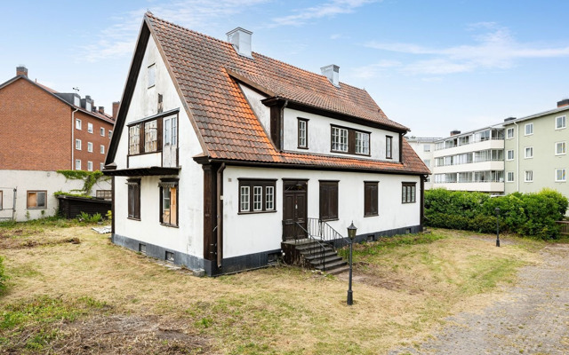 Ett litet vitt hus med brunt tak.