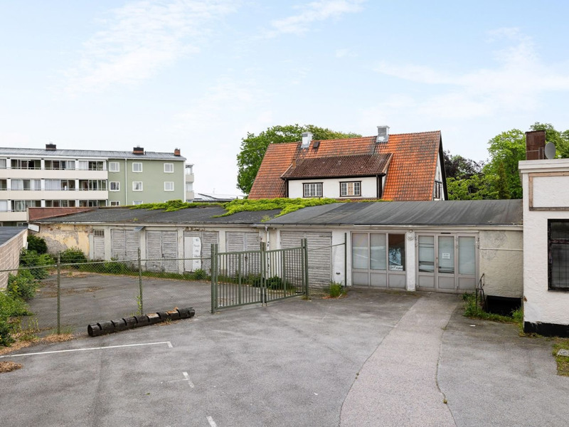 En tom parkeringsplats framför några byggnader.