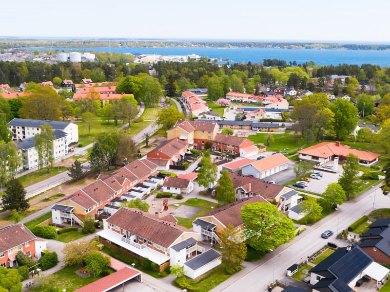 En flygbild av en stad med en sjö i bakgrunden.